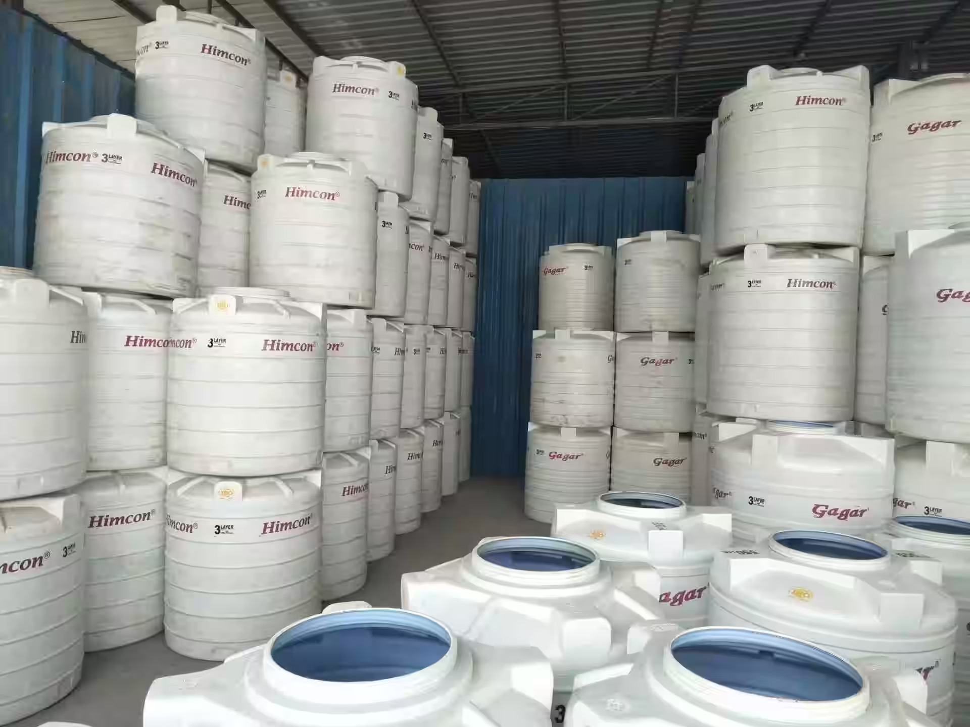 Triple layer and insulated overhead water tanks stacked at warehouse
